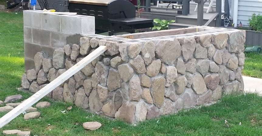 holding up heavy field stone in cinder block grill island