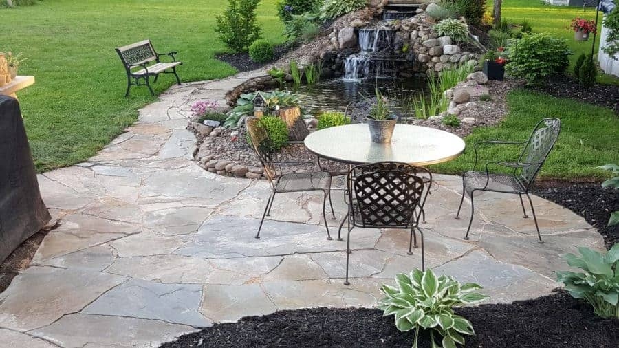 flagstone patio by the backyard waterfall