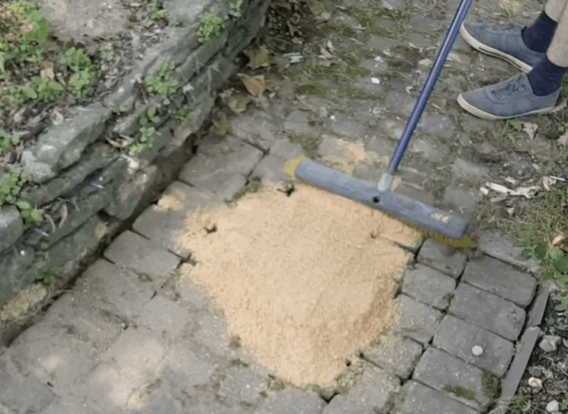 paving sand in a brick walkway