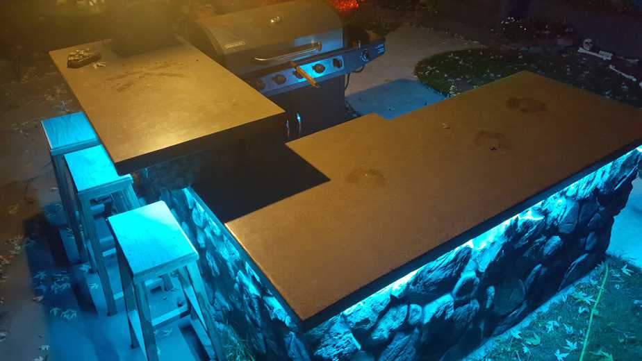 led lighting under backyard grill island blue